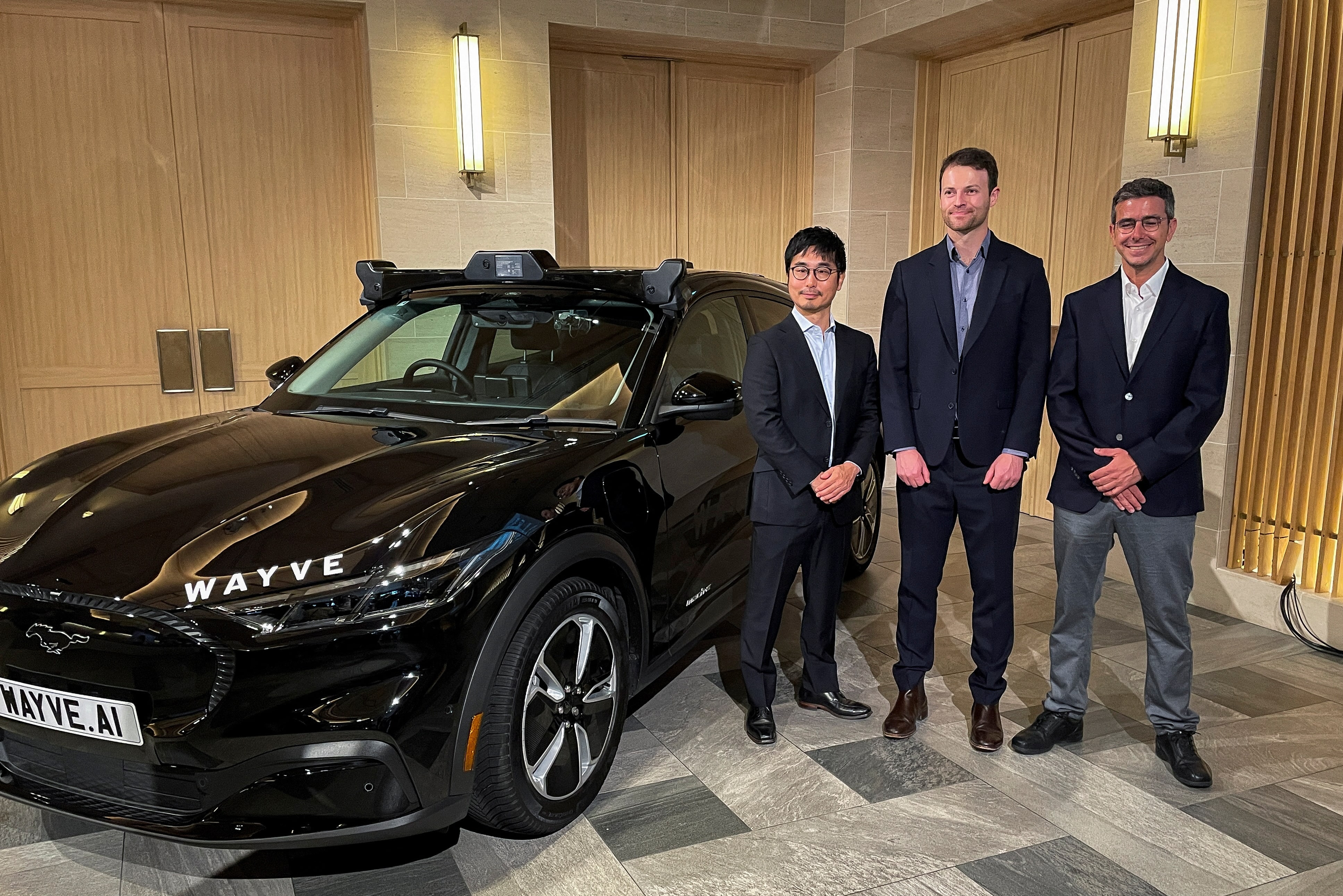 Executives from UK self-driving startup Wayve and SoftBank attend an event